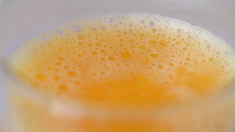 close up spinning glass of orange juice