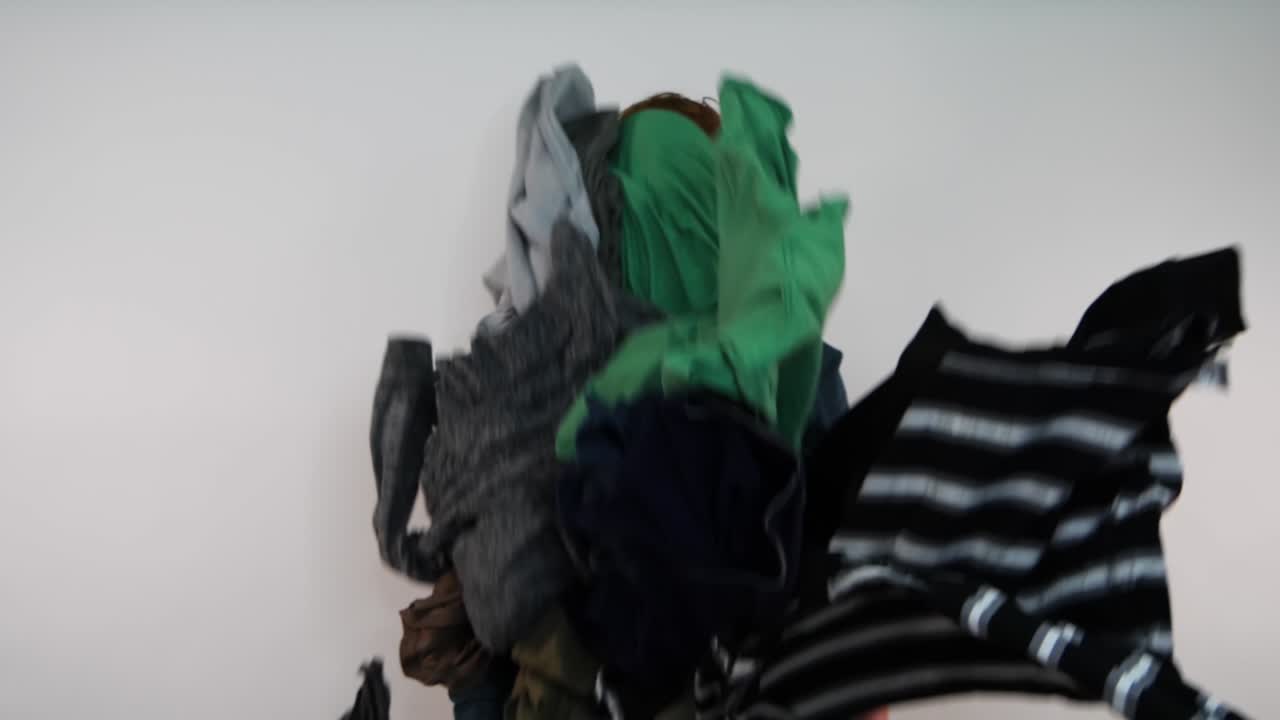 A man is hit by falling laundry seemingly overwhelmed emotionly