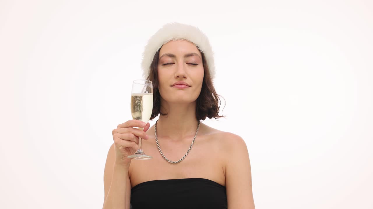 Woman in Santa Hat Drinking Champagne