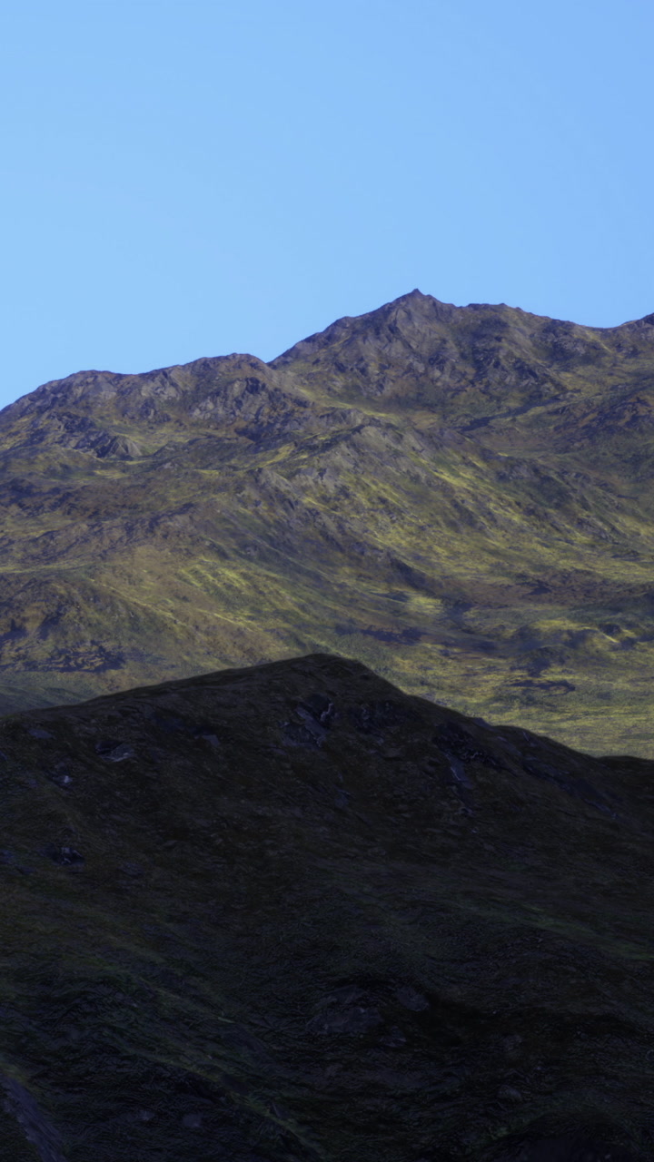 Mountain landscape with rocky terrain and clear blue sky in daytime