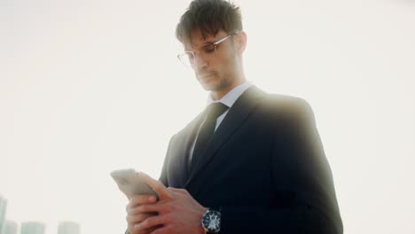 businessman using smartphone outdoors