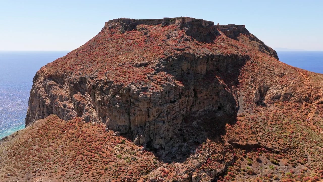 Vista aerea con drone dell'isola dalla cima piatta di Imeri Gramvousa coronata dalla fortezza veneziana in rovina sopra il mare, Gramvousa, Grecia
