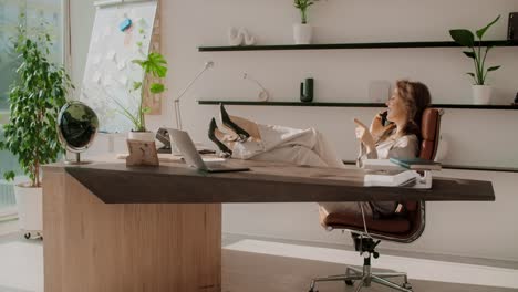 business woman relaxing at modern office desk