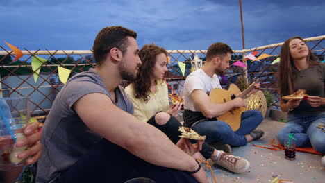 rooftop party friends enjoying pizza