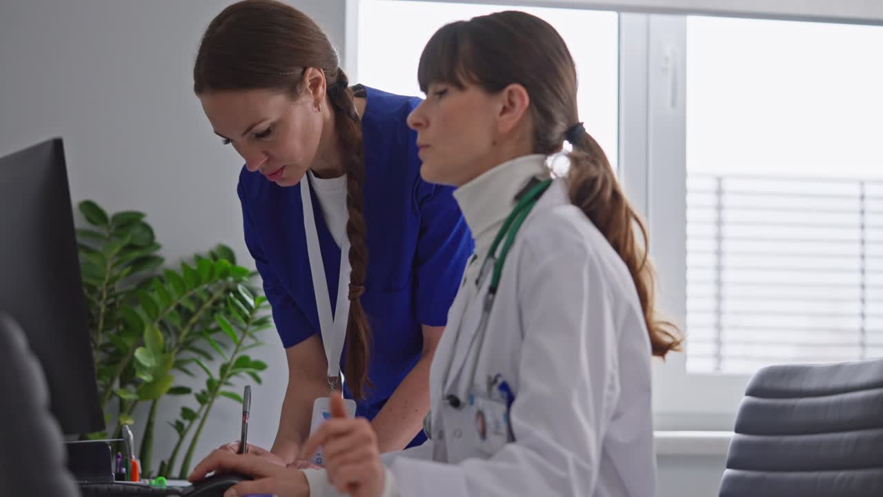 Doctors Discussing Patient Case at Computer