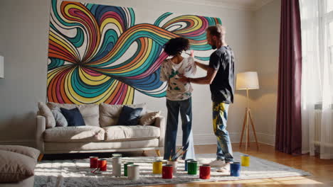 couple painting mural in living room