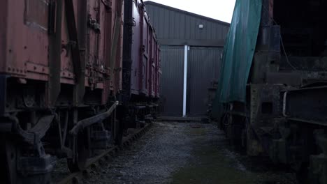 stationary wooden cargo train carriages wide tilting shot