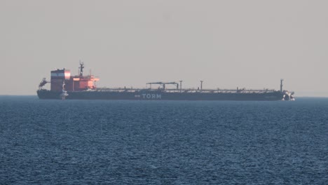 large cargo ship moving across calm ocean waters