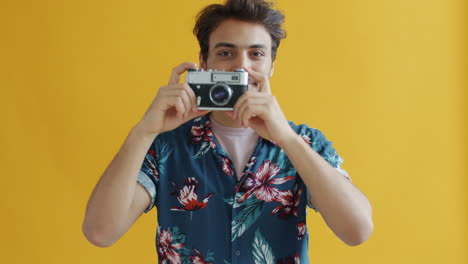 man taking a photo in a floral shirt