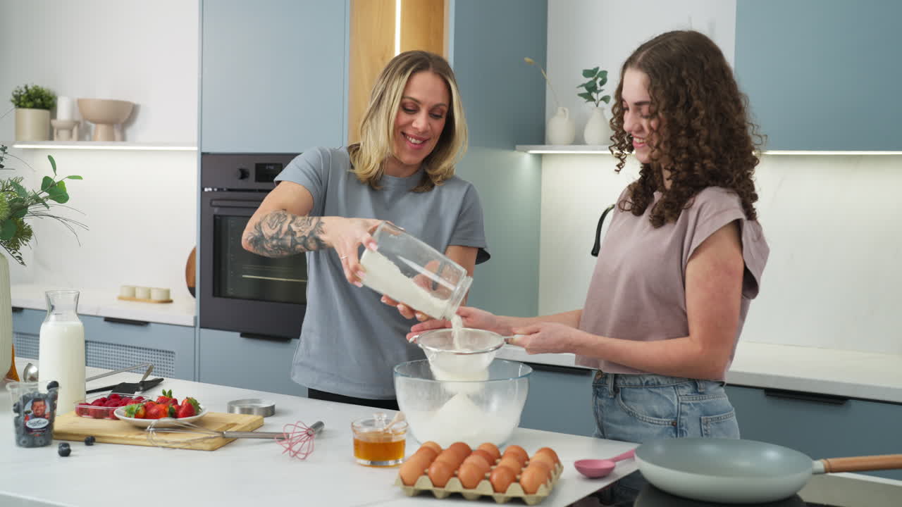Mother and daughter having a fun time in the kitchen