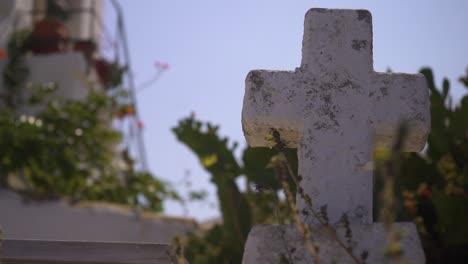 a white cross on top of an old church building in greece