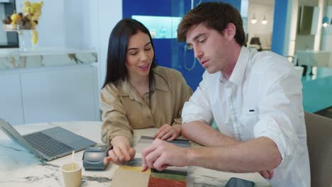 people discussing fabric samples at a table
