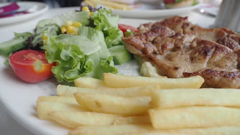 chicken with french fries and salad