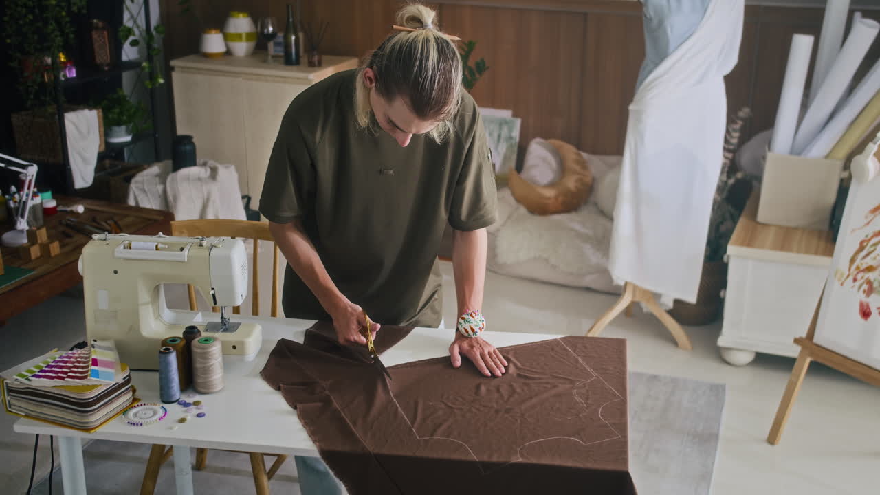 Gen Z Designer Making Cuts on Fabric at Atelier