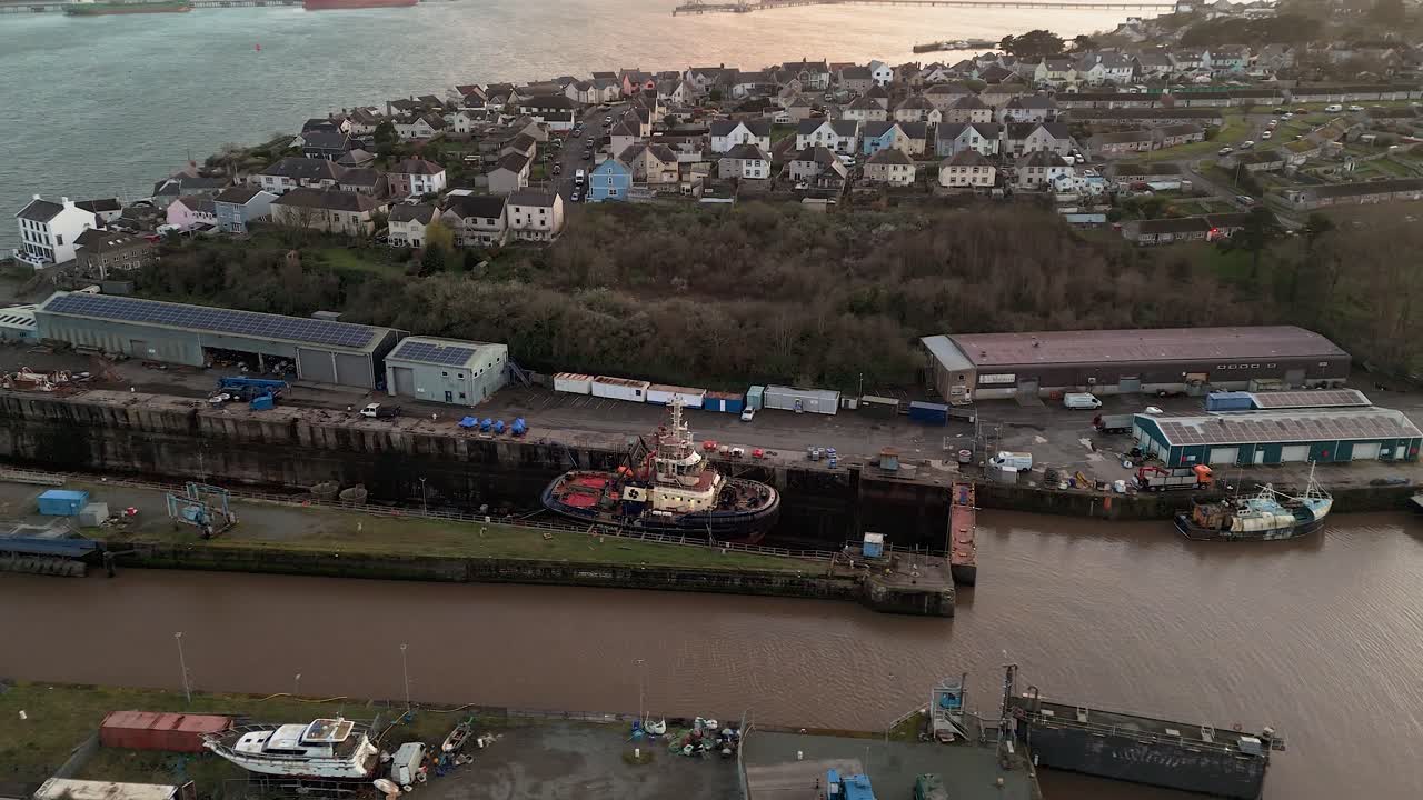 Milford waterfront, pembrokeshire, showing harbor, tugboat, and surrounding buildings, aerial view