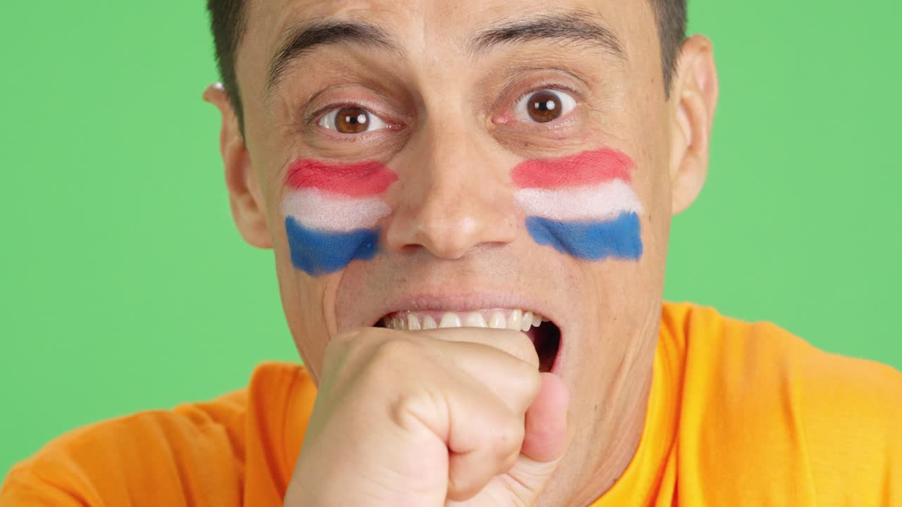 Very nervous man supporting dutch team during a difficult match