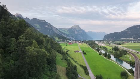 Aerial-view-of-cars-on-a-summer-road-winding-through-the-mountainous-landscape-of-Glarus-Nord,-Schweiz