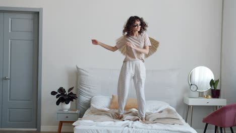 woman dancing on a bed