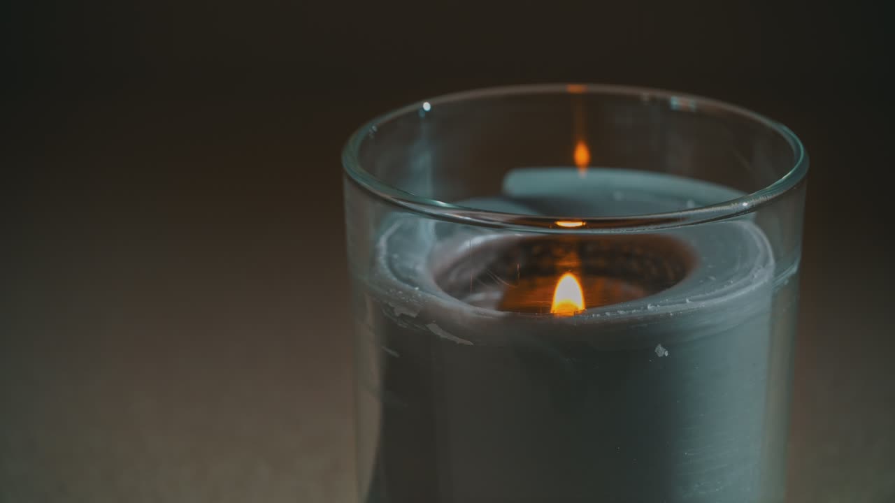 Atmospherically, a Candle Burns, Emitting Its Own Shadow in the Evening