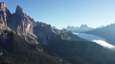 aerial of monte cristallo mountain with clear blue sky, and sunrise