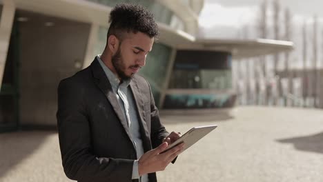 Concentrated businessman working with digital device outdoor