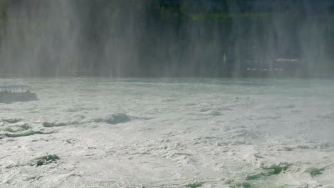 rhine falls at schaffhausen with ferry boat on giant waves,static panorama shot