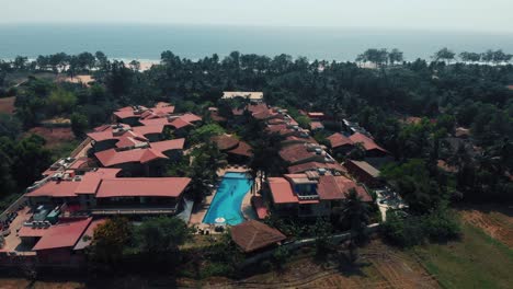 cinematic drone shot flying off a resort in goa, india