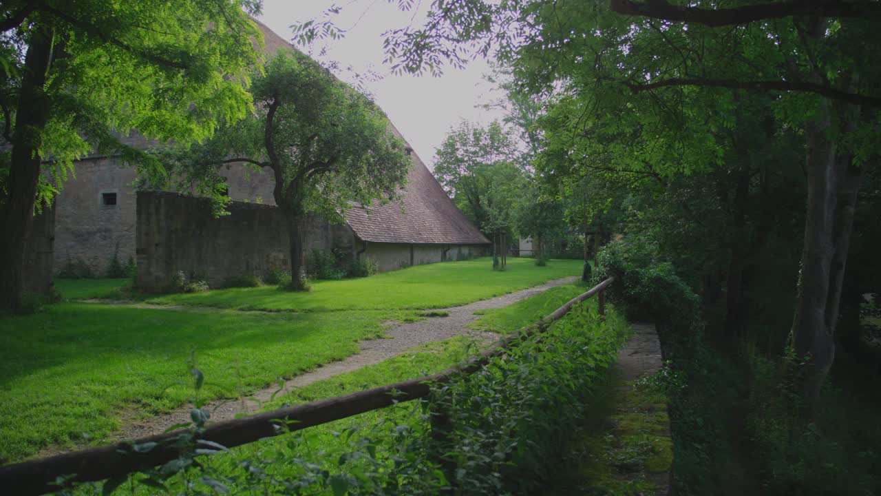 Serene garden path leading to a historical building in Rothenburg ob der Tauber