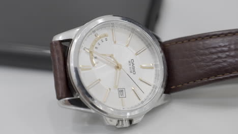 casio wristwatch with brown leather strap