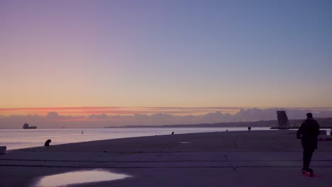 lisbon tagus river northern view at sunset with horizon clouds and electric scooter passing by 4k