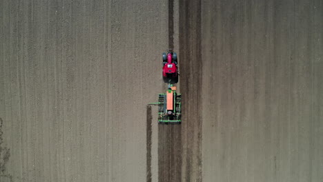 red-tractor-driving-through-a-farm-field