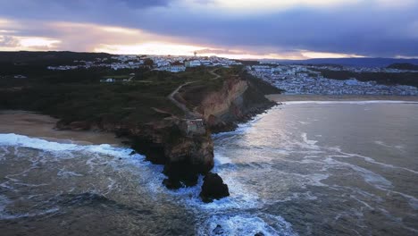 an iconic place on the atlantic coast, the mecca of big-wave surfing. view of nazare's lighthouse in zon north canyon, place with the biggest waves in europe, nazare, portugal