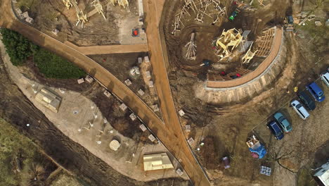 an aerial shot of an building construction taking place with construction vehicles