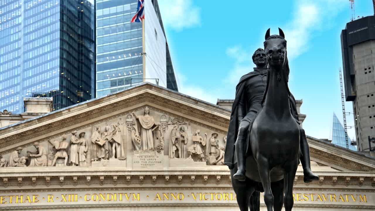 View of The Royal Exchange historical building and Equestrian statue of the Duke of Wellington located in London City district, skyscrapers on the background, United Kingdom