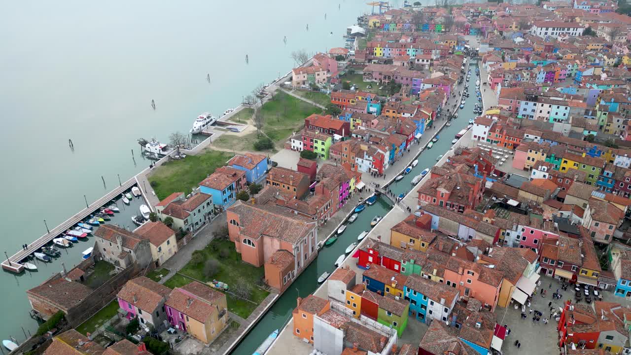 Aerial Reveal of Burano Canal and Painted House Facades, Island Province Of Venice In Italy On A Foggy Day.