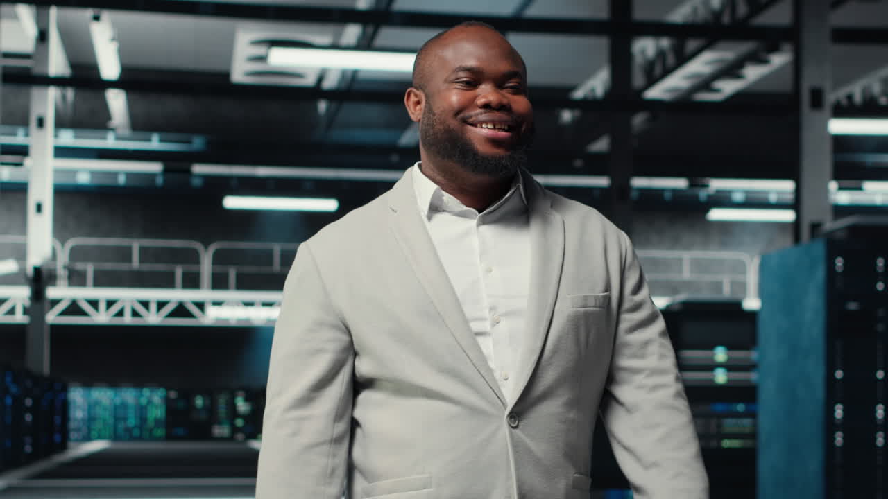 Vertical video Portrait of smiling admin doing yearly checkup on data center electronics