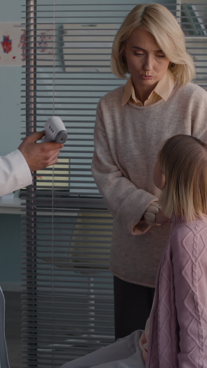 Doctor Checking Child's Temperature