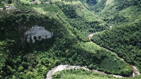 Aerial-view-following-winding-valleys-through-Magdalena-San-Agustin-lush-green-woodland-in-Andes-mountains