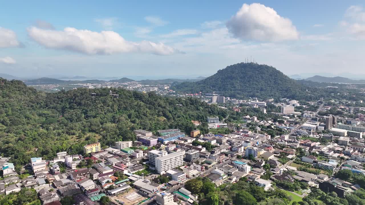 Round hills and urban area with streets and roads in Phuket city, Thailand. Aerial drone