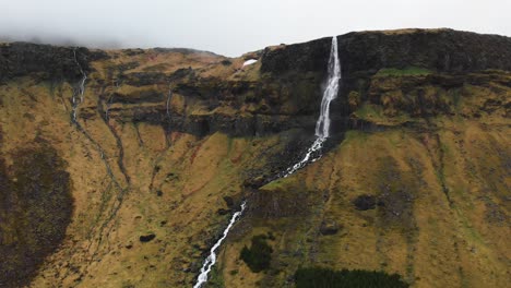 Aerial-video-going-towards-the-incredible-waterfall-Bjarnarfoss-located-in-the-high-mountains-of-Iceland
