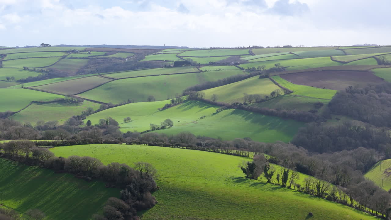 Lush green rolling hills and meadows in South Devon countryside