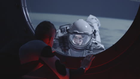 astronaut spacewalk viewed through a spacecraft window