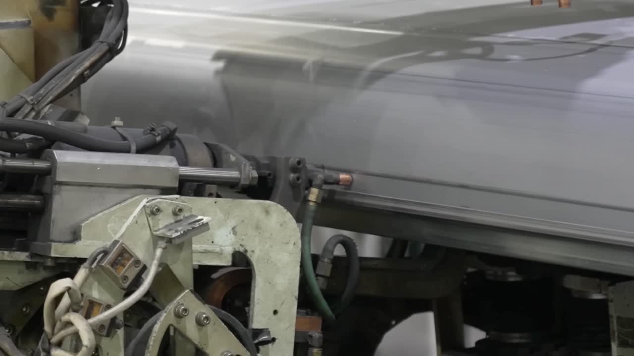 Automated spot welding machine applying pressure and heat to join sheet metal panels