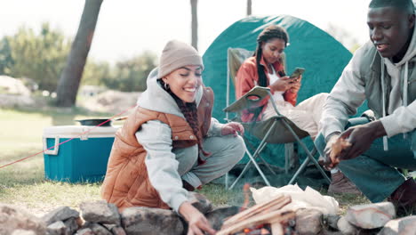 friends camping and building a bonfire