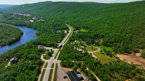 Drone-tracking-a-truck-driving-through-the-Utsjoki-village,-summer-in-Finland