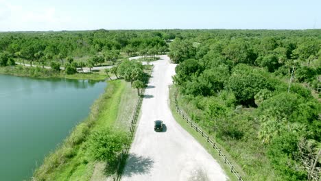 aerial shot of a car riding through an empty rural road