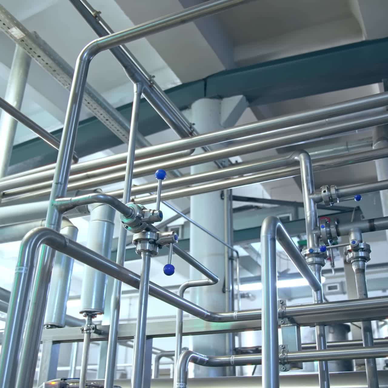 Large pipes for dairy products. Large metal pipes for the preparation of dairy products in a factory