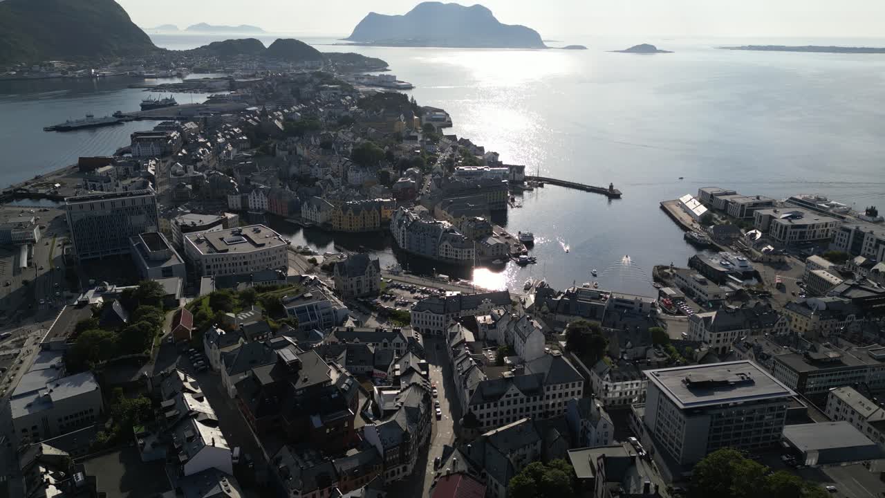 4K drone footage moving forward and sideways over Ålesund, Norway, showcasing the colorful coastal city, harbor, and islands under bright summer sunlight with smooth cinematic motion