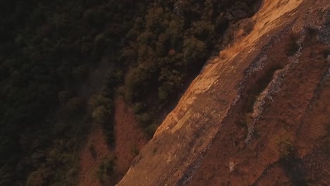 aerial view of mountain cliff and forest