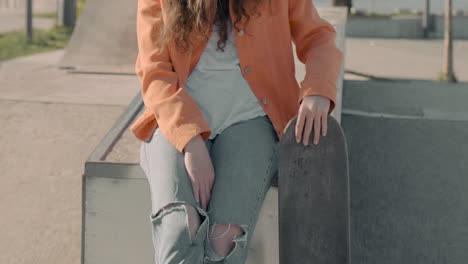 skater girl waiting for someone sitting on a skate park 3